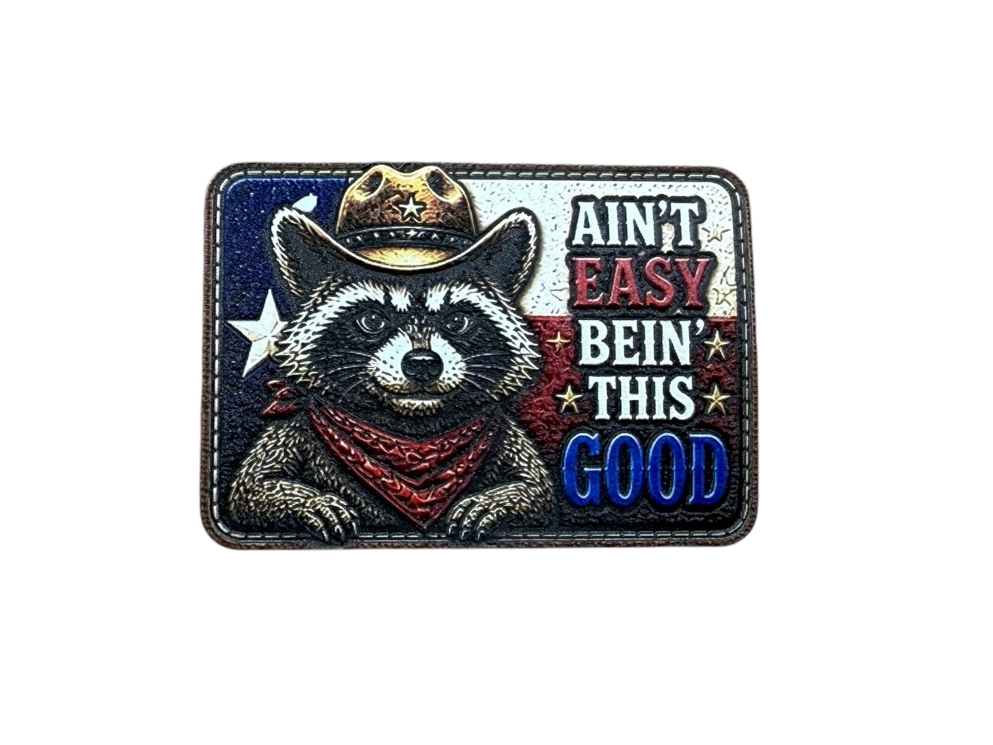 Patch with a raccoon wearing a cowboy hat and bandana, featuring text 'Ain't Easy Bein' This Good' on a white background.
