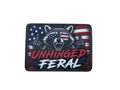 Patch with a raccoon design, American flag, and text 'Unhinged Feral' on a white background