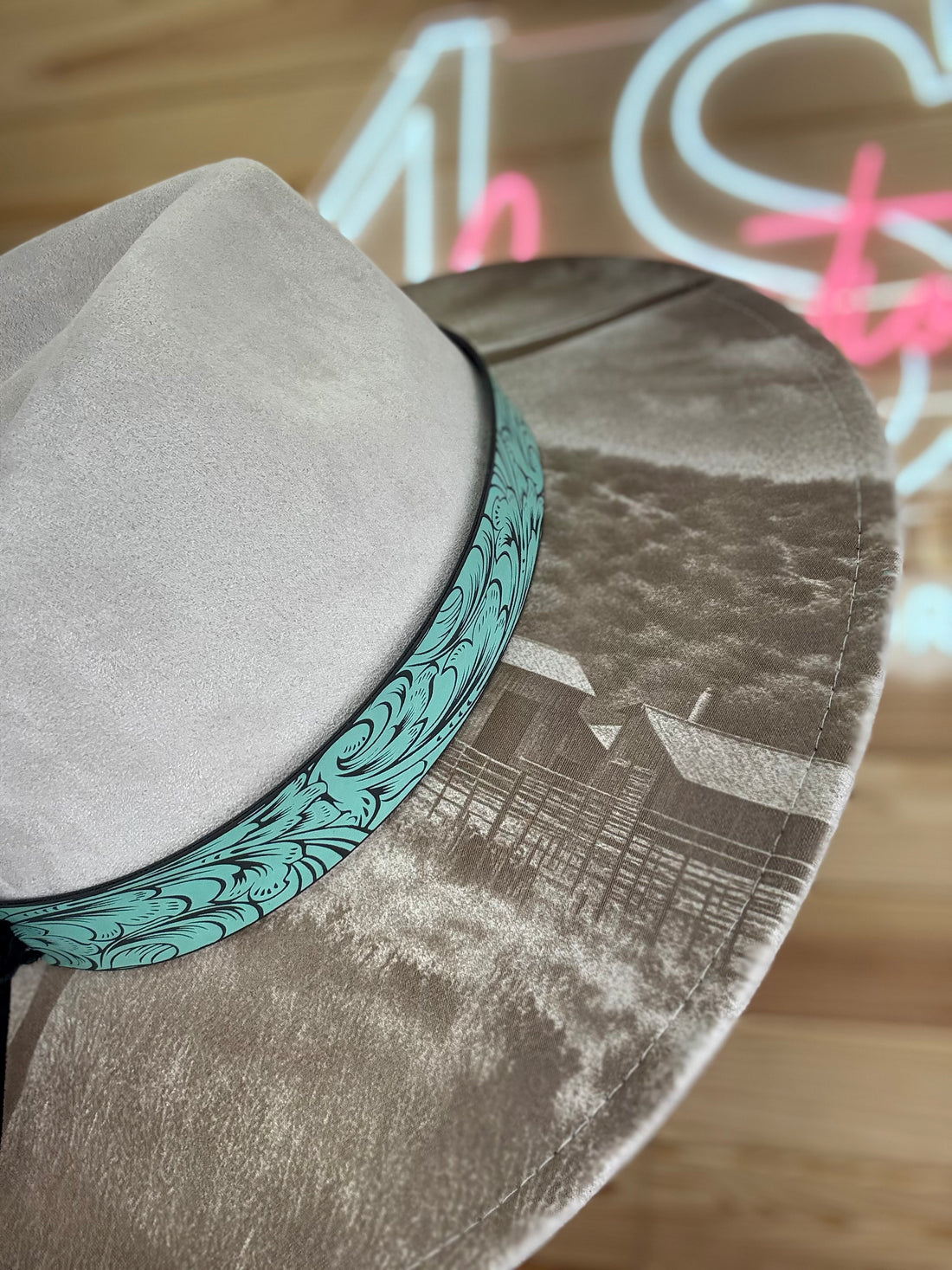 Circular product with cow illustration on a wooden surface with neon lights in the background