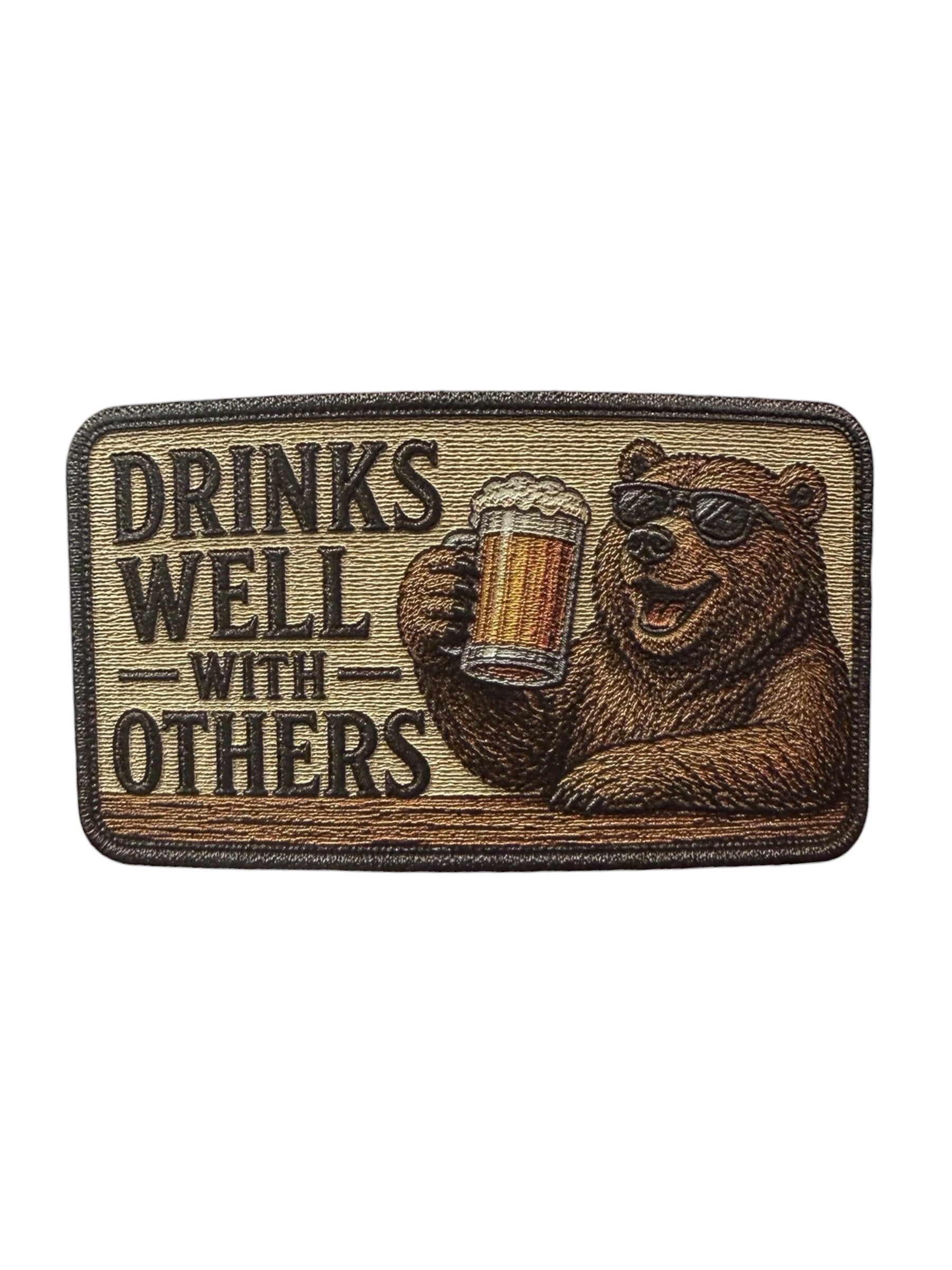 UV texture patch with a bear holding a beer and 'Drinks Well with Others' text on a white background.