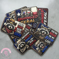 Collection of raccoon-themed patches with text on a gray surface, featuring the brand 'LFG'.
